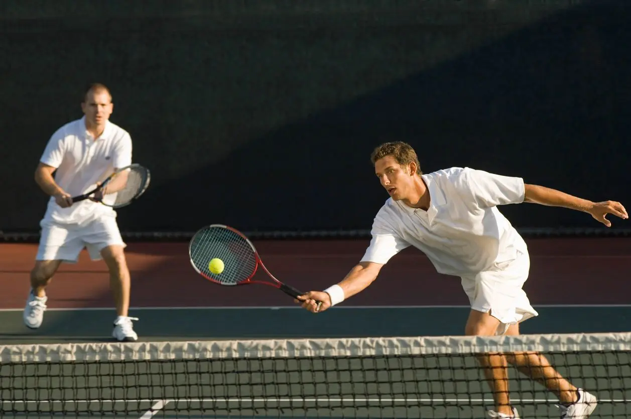 Tennis Player Swinging at Ball